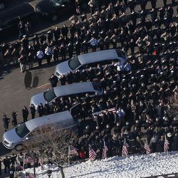 The casket is loaded into a waiting hearse after the funeral of Utah Highway Patrol trooper Eric Ellsworth at the Dee Events Center in Ogden on Wednesday, Nov. 30, 2016.