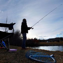 Easton Monsen braves cold temperatures Sunday, Feb. 22, 2015, as he fishes at the pond at Herriman Springs.