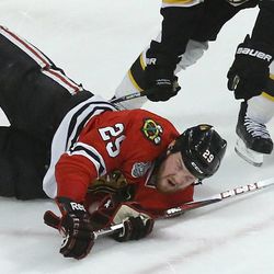 Chicago Blackhawks left wing Bryan Bickell (29) falls to the ice while trying to wrap the puck around the goal against the Boston Bruins during Game 2 of the NHL hockey Stanley Cup Finals, Saturday, June 15, 2013, in Chicago.