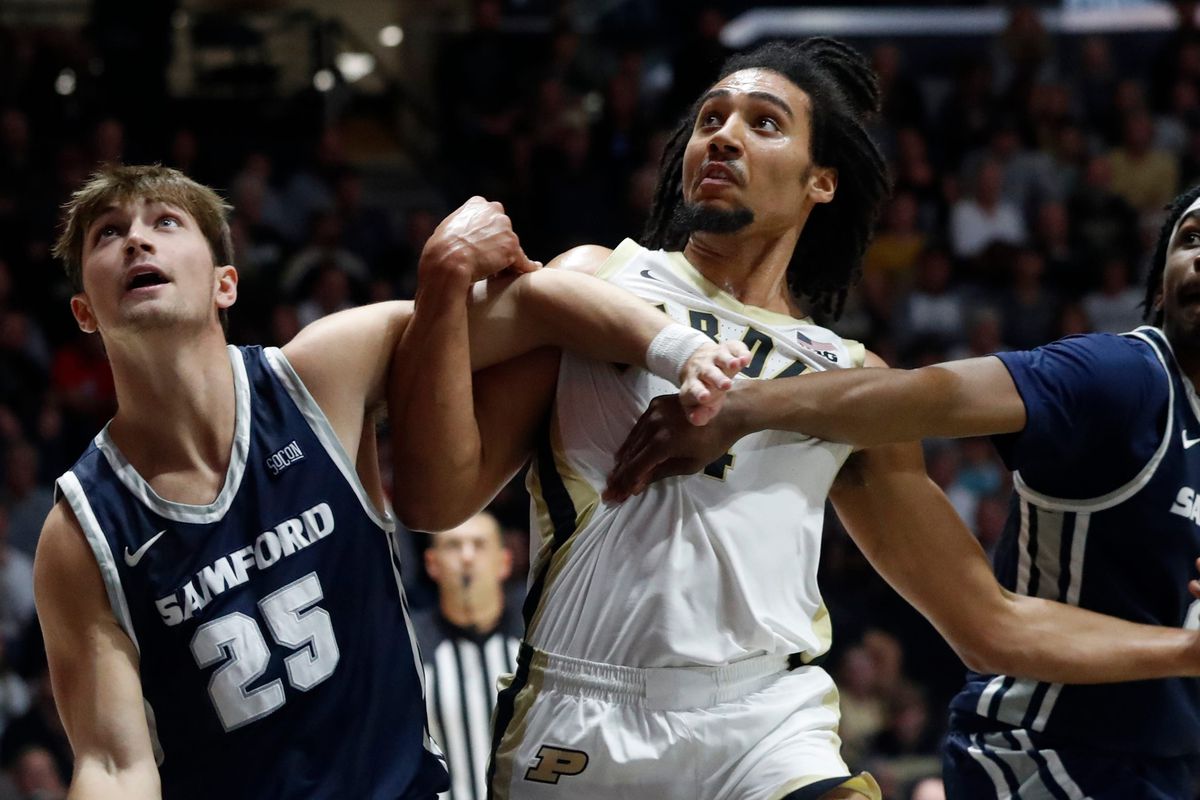 Samford Bulldogs forward Nathan Johnson and Samford Bulldogs guard Jaden Campbell box out Purdue Boilermakers forward Trey Kaufman-Renn during the NCAA men s basketball game, Monday, Nov. 6, 2023, at Mackey Arena in West Lafayette, Ind.