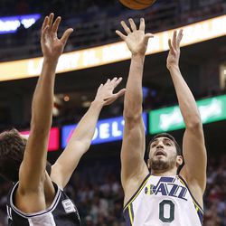 Utah Jazz's center Enes Kanter (0) shoots over Spurs' Marco Belinelli as the Utah Jazz and the San Antonio Spurs play Saturday, Dec. 14, 2013 at EnergySolutions Arena in Salt Lake City. The Spurs won 100-84.