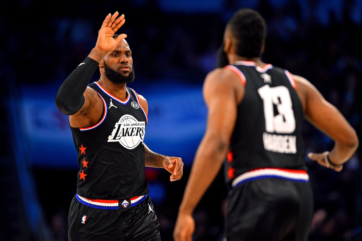 Team Lebron forward Lebron James of the Los Angeles Lakers reacts with Team Lebron guard James Harden of the Houston Rockets during the 2019 NBA All-Star Game at Spectrum Center.