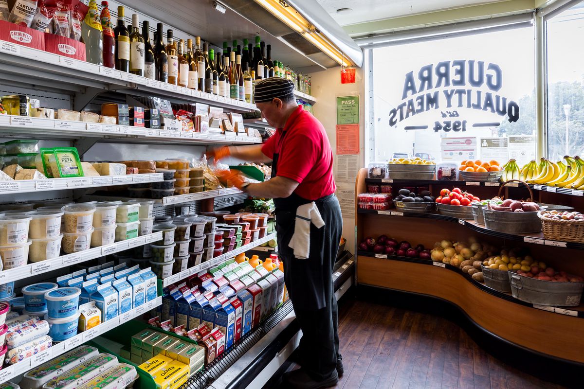 A man stocks shelves inside Guerra Quality Meats.