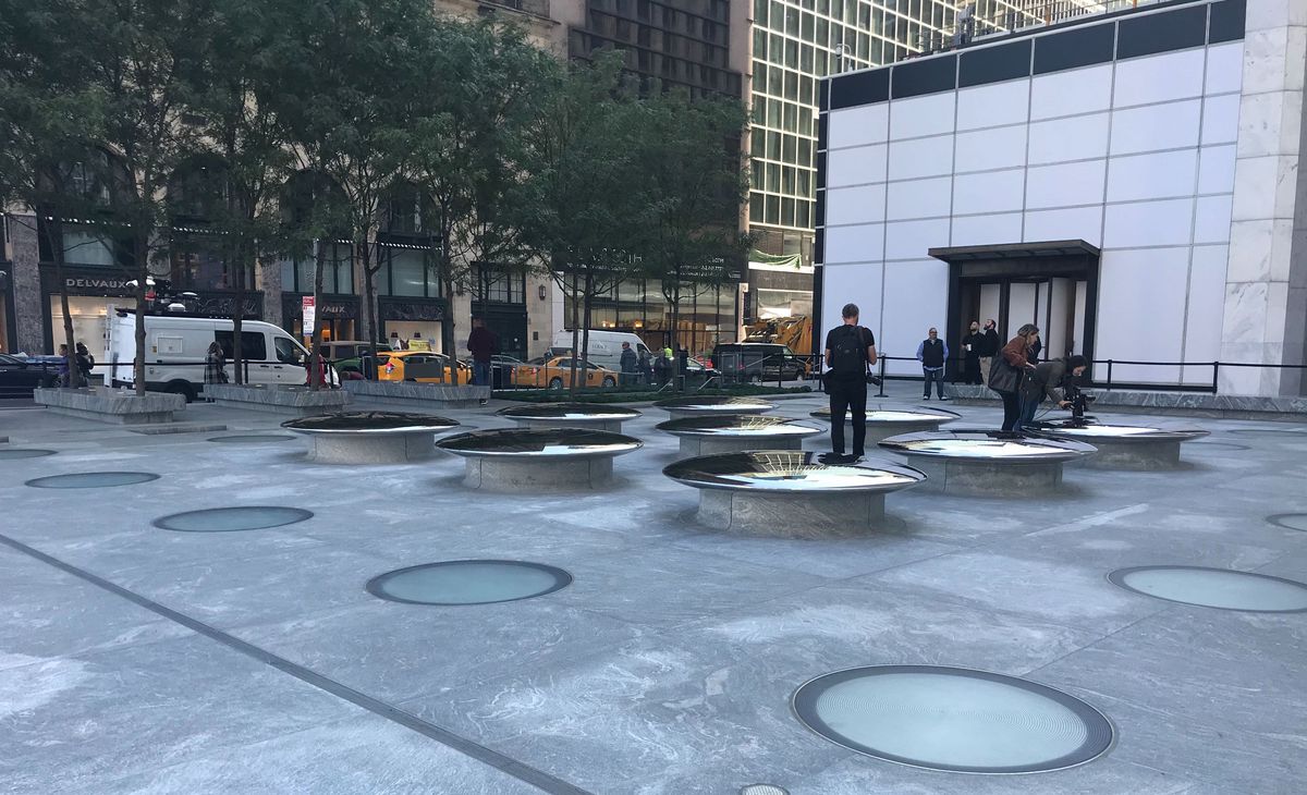 A plaza with circles and round lifted structures that act as chairs. 