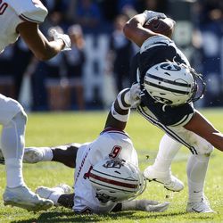 UMass Minutemen safety Tedrick Lowery (6) takes down Brigham Young Cougars defensive back KJ Hall (20) on a run during a game at LaVell Edwards Stadium in Provo on Saturday, Nov. 19, 2016.