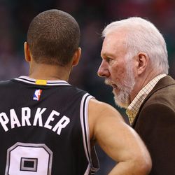 San Antonio Spurs head coach Gregg Popovich talks with Tony Parker as the Utah Jazz defeat the San Antonio Spurs 90-81 in NBA basketball Monday, Feb. 23, 2015, in Salt Lake City.  
