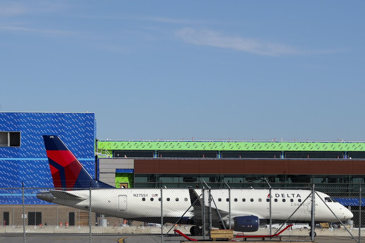 A jet passes the north concourse under construction at Salt Lake City International Airport in Salt Lake City on Monday, Sept. 23, 2019. Officials noted the $3.6 billion redesign of the airport is on final approach, with less than a year to go until its first phase is slated to open to the public on Sept. 15, 2020.