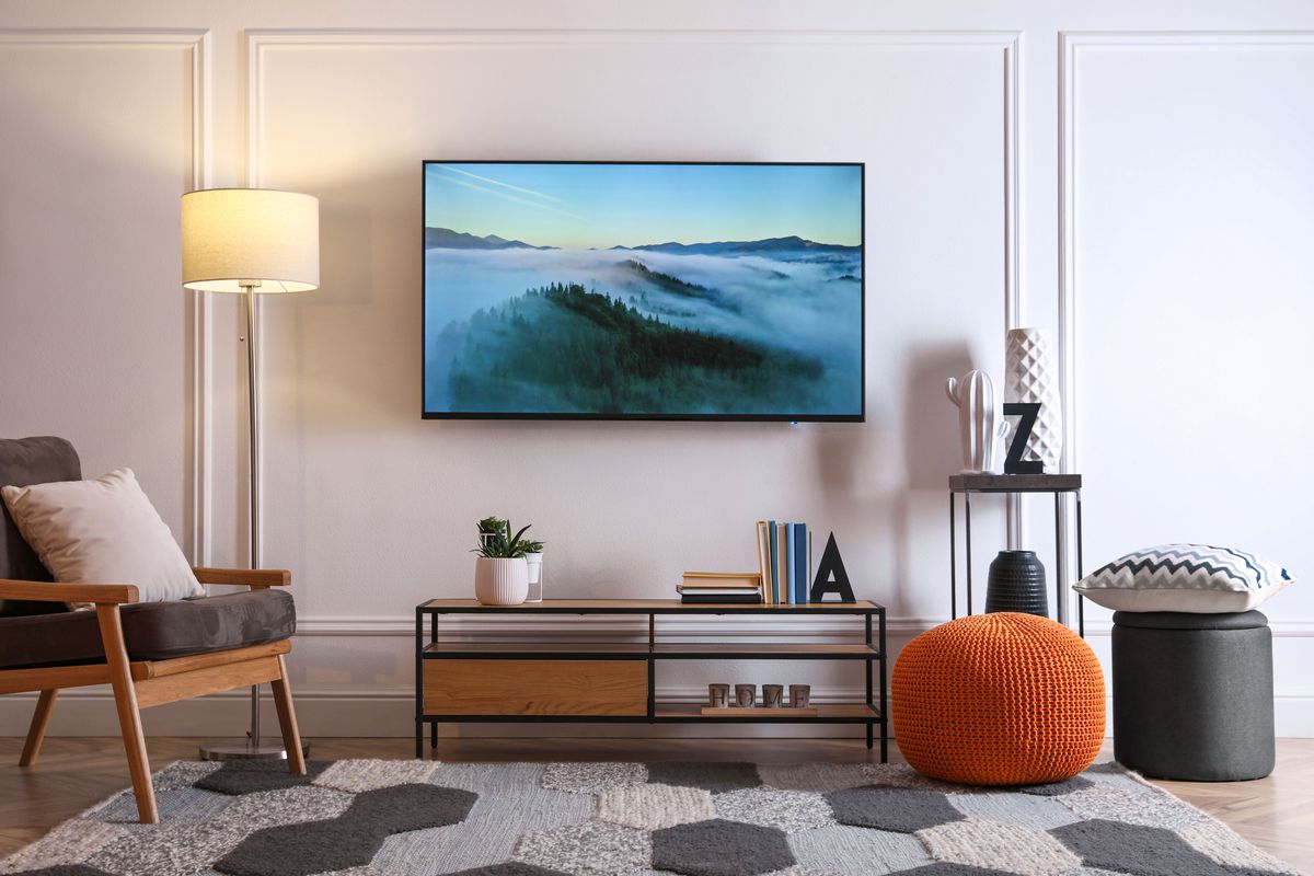 a flat screen TV mounted on a wall in a contemporary living space
