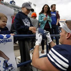 Brigham Young Cougars receiver Mitchell Juergens, right, signs autographs before a spring football scrimmage at LaVell Edwards Stadium in Provo, Saturday, March 26, 2016.