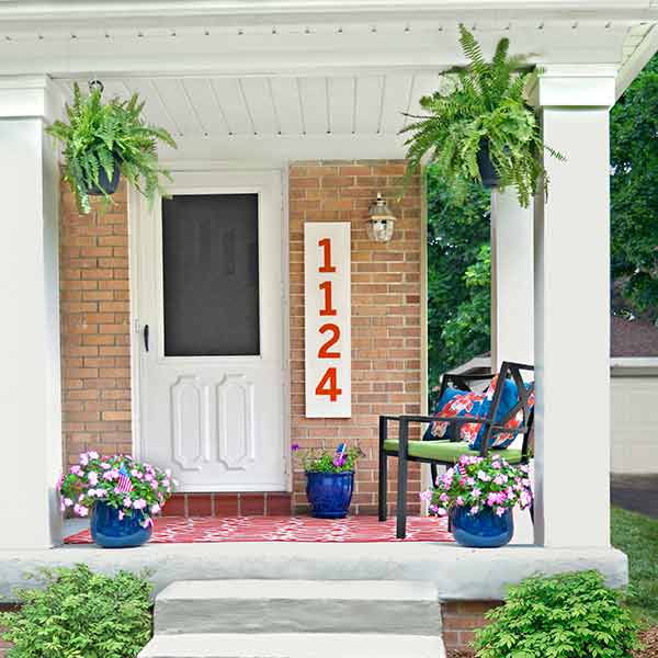 <p><strong>After:</strong> Wood-wrapped columns, a refinished floor and steps, and cheery accessories lend curb appeal and make visitors feel welcome.</p>