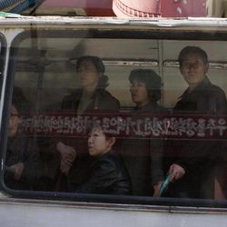 In this Friday, April 12, 2013 file photo, North Korean commuters ride on a trolley car in Pyongyang, North Korea on Friday, April 12, 2013. Reflected in the window is a roadside propaganda banner that reads: "Let's follow the example of the space conquerors," referring to the country's rocket launch program.