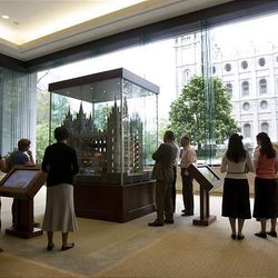 People view a scaled architectural model of the LDS Salt Lake Temple that was placed on display Friday in the South Visitors' Center at Temple Square in Salt Lake City. 