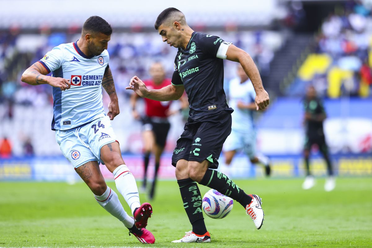 Juan Escobar of Cruz Azul fights for the ball with Juan Brunetta of Santos during the 4th round match between Cruz Azul and Santos Laguna as part of the Torneo Apertura 2023 Liga MX at Azteca Stadium on August 20, 2023 in Mexico City, Mexico.