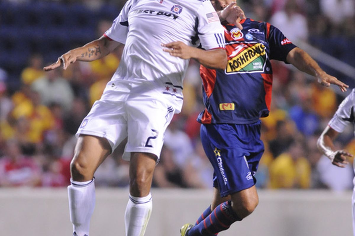 BRIDGEVIEW IL - JULY 14:  Luis Gabriel Rey #18 of the Monarcas Moreliais is defended by C.J. Brown #2 of the Chicago Fire in a SuperLiga match on July 14 2010 at Toyota Park in Brideview Illinois. (Photo by David Banks/Getty Images)