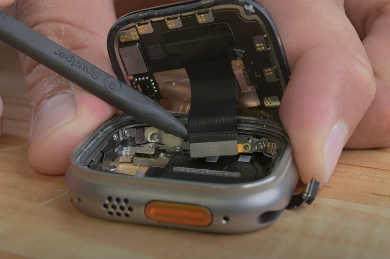 A photo detailing the inside of a disassembled Apple Watch Ultra with its screen removed