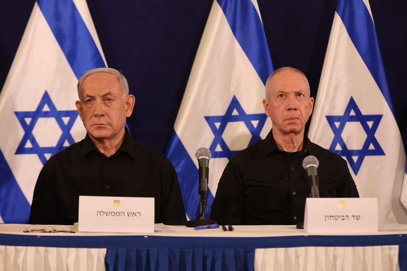 netanyahu and gallant in front of israeli flags