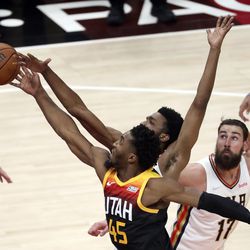 Utah Jazz guard Donovan Mitchell (45) shoots as New Orleans Pelicans forward Herbert Jones (5) knocks the ball away during an NBA game at the Vivint Arena in Salt Lake City on Friday, Nov. 26, 2021. The Jazz lost 97-98.