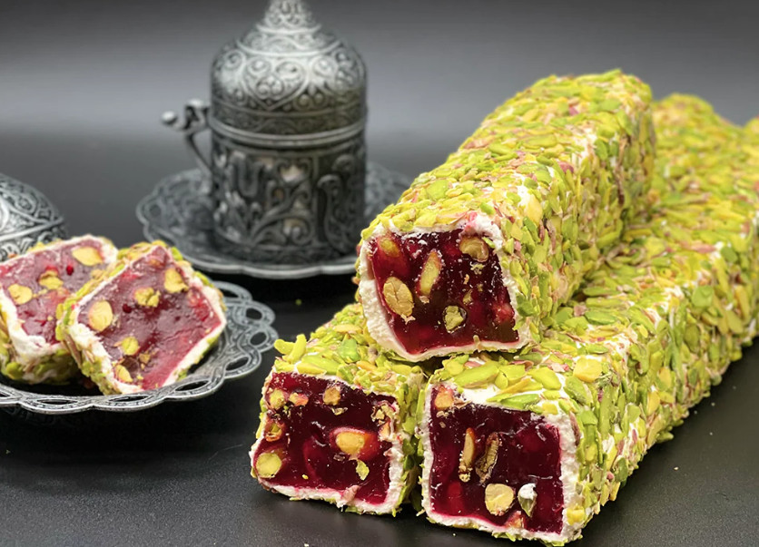Green and red Turkish delight sliced and placed on pewter dishes.