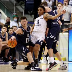 Utah State Aggies guard Rylan Jones (15) is fouled by Brigham Young Cougars guard Te’Jon Lucas (3) as BYU and Utah State play an NCAA basketball game in Provo at the Marriott Center on Wednesday, Dec. 8, 2021. BYU won 82-71.