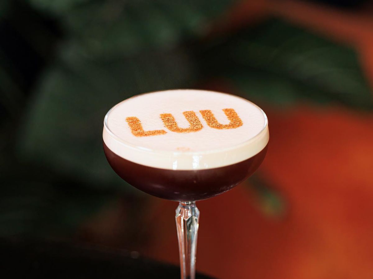 A cocktail with the name Luu stenciled on foam.