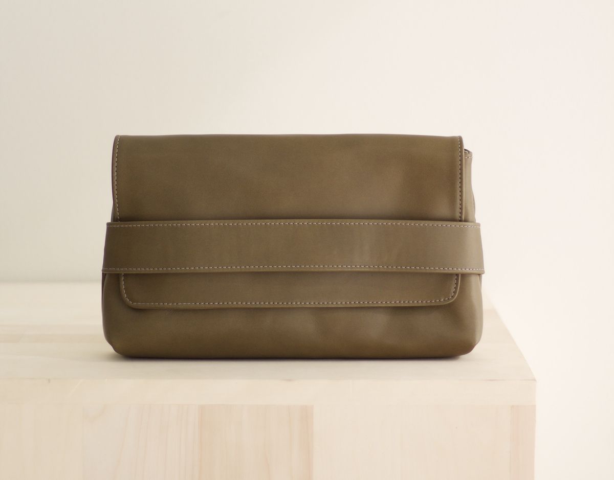 A Ceri Hoover olive colored clutch