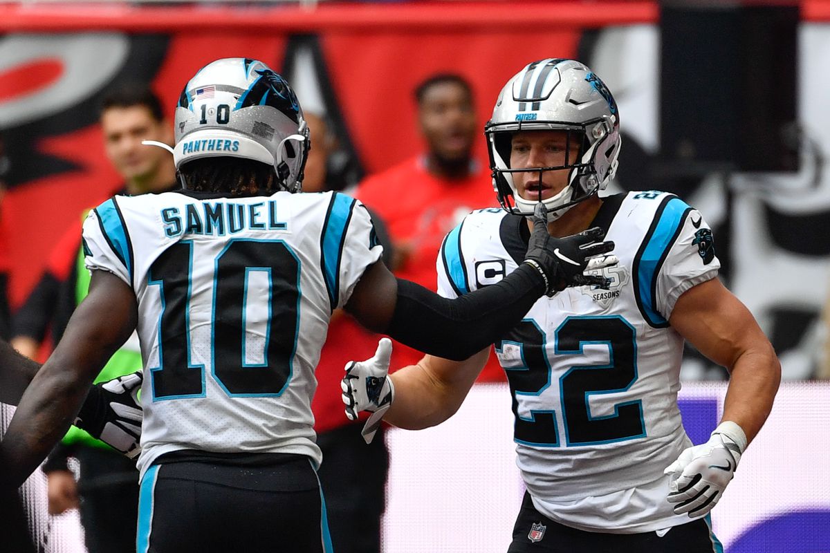 Carolina Panthers wide receiver Curtis Samuel celebrates with running back Christian McCaffrey after his touchdown during the second quarter of the game between the Panthers and the Tampa Bay Buccaneers at Tottenham Hotspur Stadium.