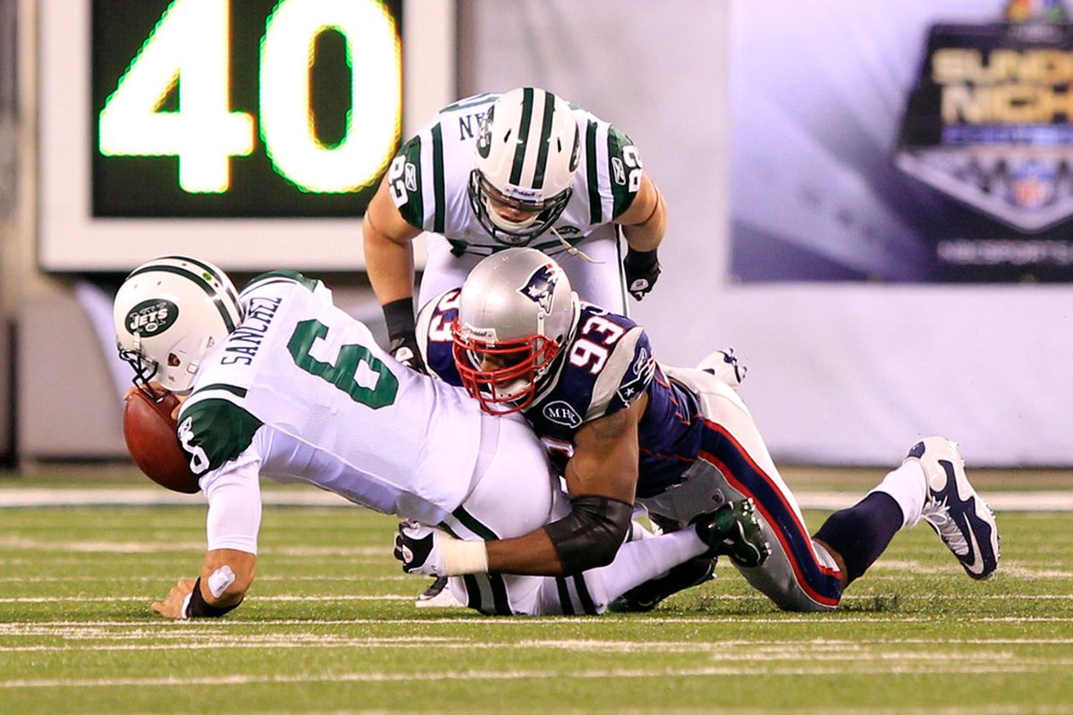 EAST RUTHERFORD, NJ - NOVEMBER 13:  Andre Carter #93 of the New England Patriots sacks Mark Sanchez #6 of the New York Jets at MetLife Stadium on November 13, 2011 in East Rutherford, New Jersey.  (Photo by Chris Trotman/Getty Images)