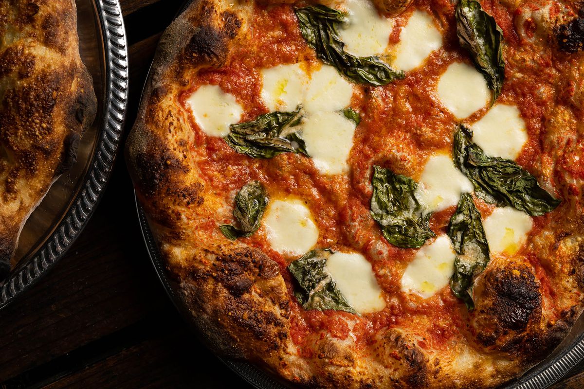 A margherita pizza with cheese and basil only at a hip restaurant.