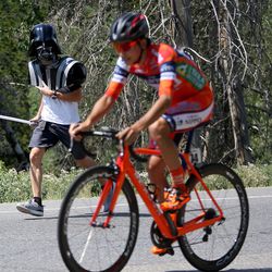Eric Sevy tells a racer "The force is with you," as he bikes up Big Cottonwood Canyon during stage 3 of the Tour of Utah on Wednesday, Aug. 2, 2017.