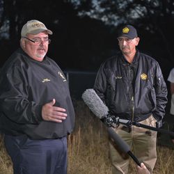 Spartanburg County Coroner Rusty Clevenger, left and Spartanburg County Sheriff Chuck Wright hold a news conference in front of Todd Kohlhepp's property in Woodruff, S.C., Sunday, Nov. 6, 2016. Authorities have found another body buried at the rural South Carolina property where a woman was found chained in a metal container. 