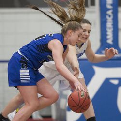 Bingham's Maggie Mccord and Fremont's Emma Calvert reach for the ball during Fremont's 61-47 victory against Bingham in the Class 6A state championship game at Salt Lake Community College in Taylorsville on Saturday, Feb. 24, 2018.