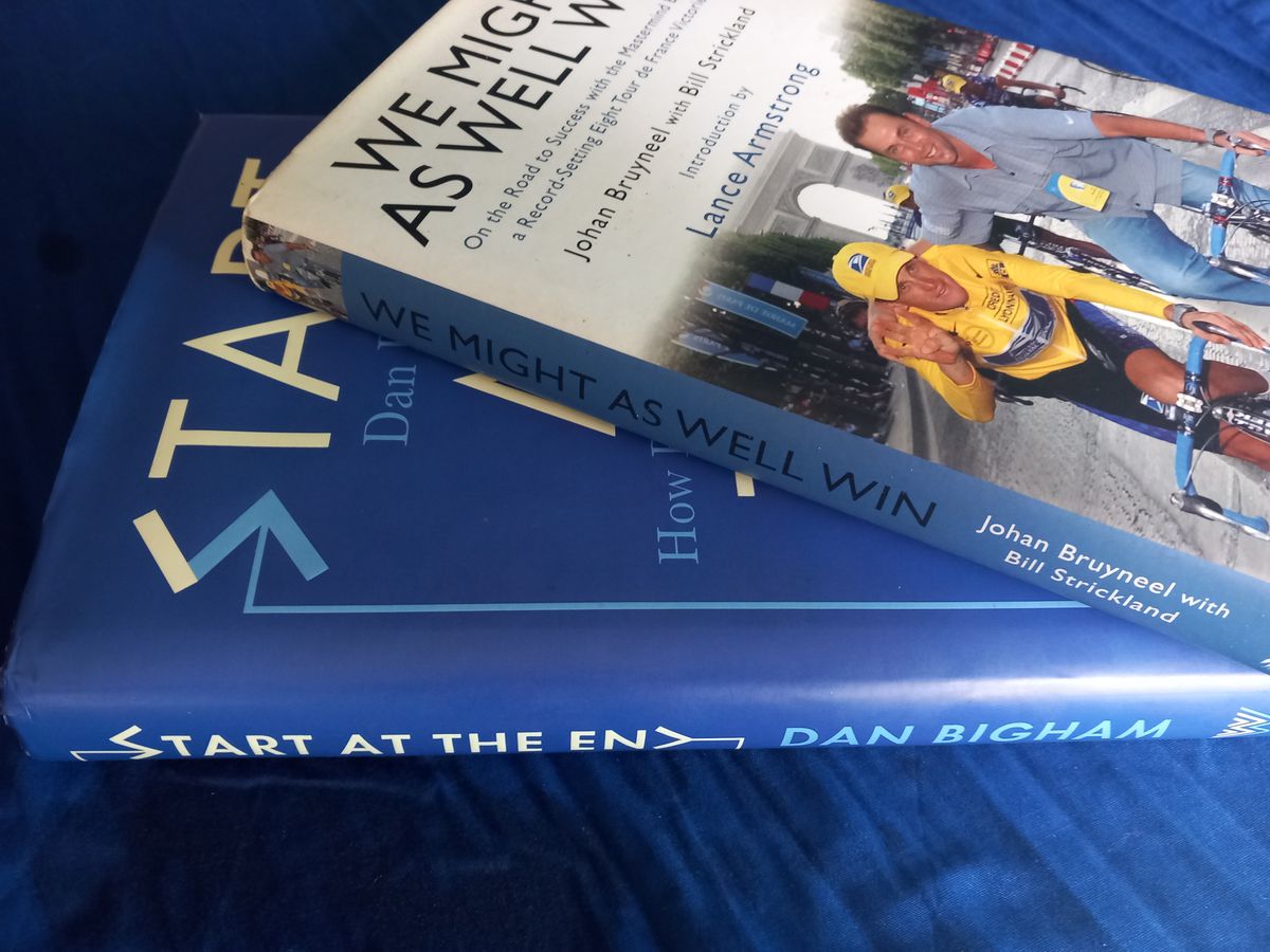 We Might as Well Start at the End – Cycling as Management Self-Help. Bigham and Bruyneel sit next to each other on the Café Bookshelf