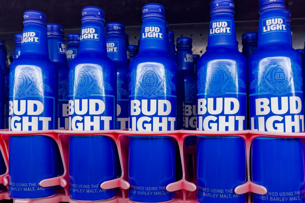 A row of blue bottles with the words “Bud Light” printed on them in white lettering. 