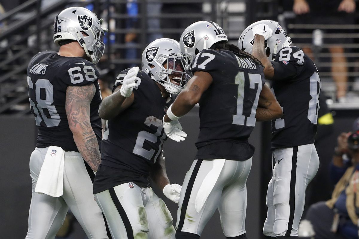 Wide receiver Davante Adams #17 of the Las Vegas Raiders celebrates with center Andre James #68, running back Josh Jacobs #28 and wide receiver Keelan Cole #84 after scoring a touchdown in the third quarter against the Los Angeles Chargers at Allegiant Stadium on December 04, 2022 in Las Vegas, Nevada.