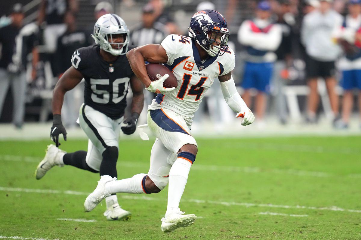 Denver Broncos wide receiver Courtland Sutton (14) runs with the ball ahead of Las Vegas Raiders linebacker Jayon Brown (50) during a game at Allegiant Stadium.