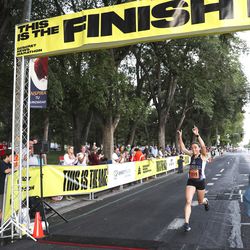 Jocelyn Todd crosses the finish line as she wins the Deseret News 10K race that finished at Liberty Park in Salt Lake City on Tuesday, July 24, 2018.