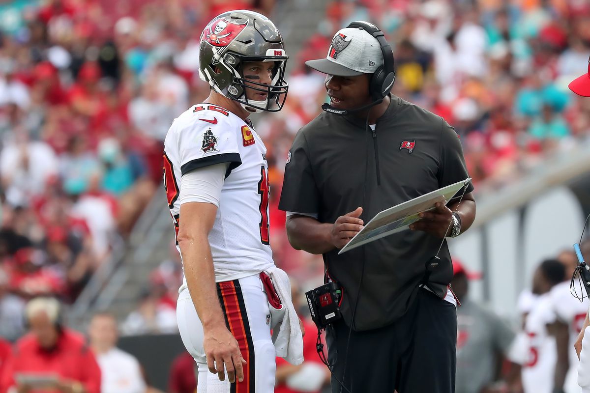 Tampa Bay Buccaneers Quarterback Tom Brady (12) talks with Offensive Coordinator Byron Leftwich during the regular season game between the Miami Dolphins and the Tampa Bay Buccaneers on October 10, 2021 at Raymond James Stadium in Tampa, Florida.