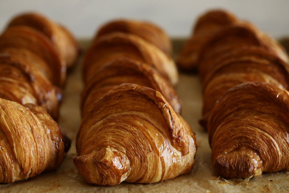Rows of croissants on paper. 