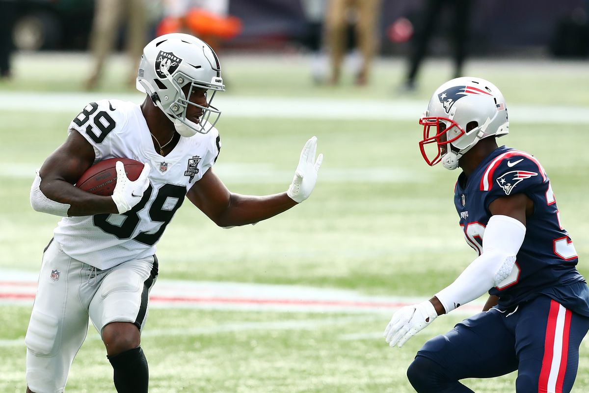 Bryan Edwards of the Las Vegas Raiders looks to stiff arm Jason McCourty of the New England Patriots during the second half at Gillette Stadium on September 27, 2020 in Foxborough, Massachusetts.&nbsp;
