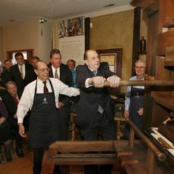 President Thomas S. Monson pulls the "devil's tail" on the replica of the Gutenberg press as Lou Crandall (left), CEO of the Crandall Historical Printing Museum watches, at the opening of the museum, Tuesday, April 21, 2009,in Provo, Utah. Tom Smart, Deseret News
