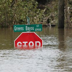 A stop sign is nearly submerged from Tropical Storm Harvey in Houston on Wednesday, Aug. 30, 2017.