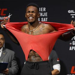 Israel Adesanya tries to rip his shirt at UFC on FOX 29 weigh-ins.