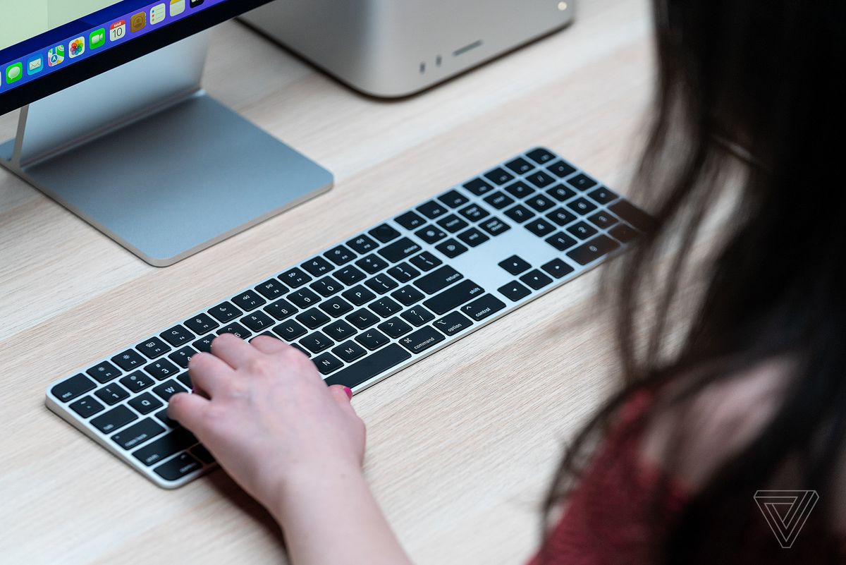 A user types on the Apple Mac Studio keyboard.