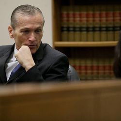 Martin MacNeill, left, speaks with his attorneys before proceedings at 4th District Court in Provo Wednesday, Oct. 30, 2013. MacNeill is charged with murder for allegedly killing his wife, Michele MacNeill, in 2007.