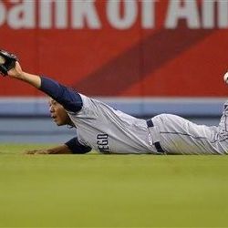 San Diego Padres left fielder Kyle Blanks holds up the ball after making a diving catch on a ball hit by Los Angeles Dodgers' Jerry Hairston Jr. during the sixth inning of their baseball game, Wednesday, June 5, 2013, in Los Angeles. (AP Photo/Mark J. Terrill)