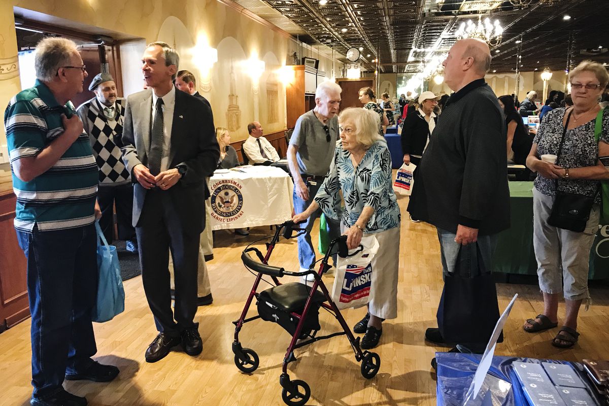 Rep. Dan Lipinski (second from the left) answers questions from elederly constituents at a senior fair in Summit, Illinois.