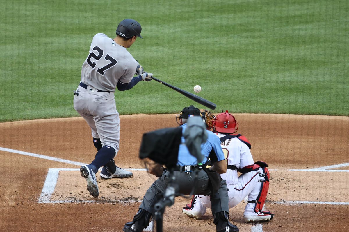 New York Yankees designated hitter Giancarlo Stanton hits a two-run home run against the New York Yankees in the first inning during MLB Opening Day at Nationals Park.