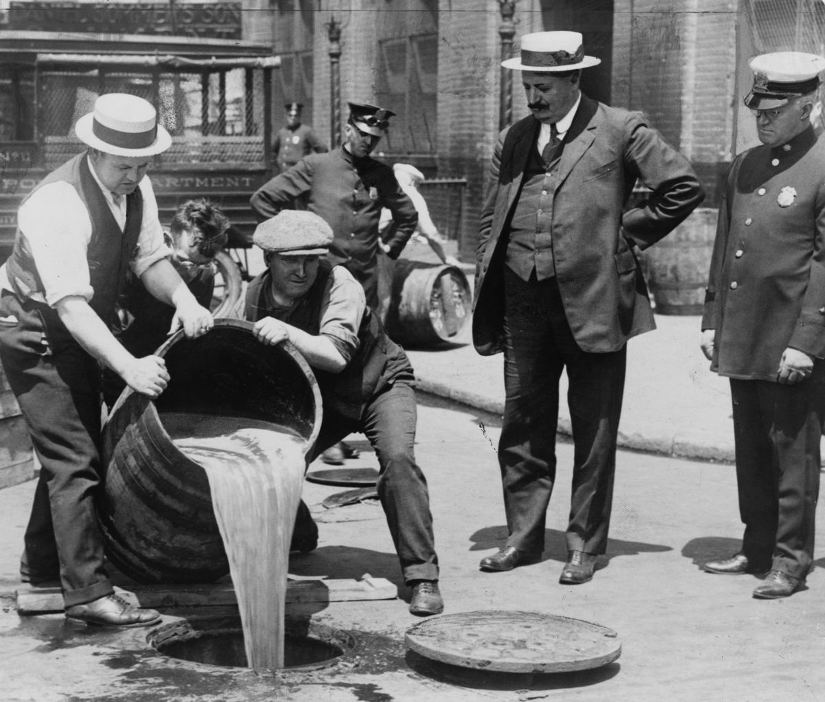 Police oversee the confiscation and destruction of liquor during Prohibition.