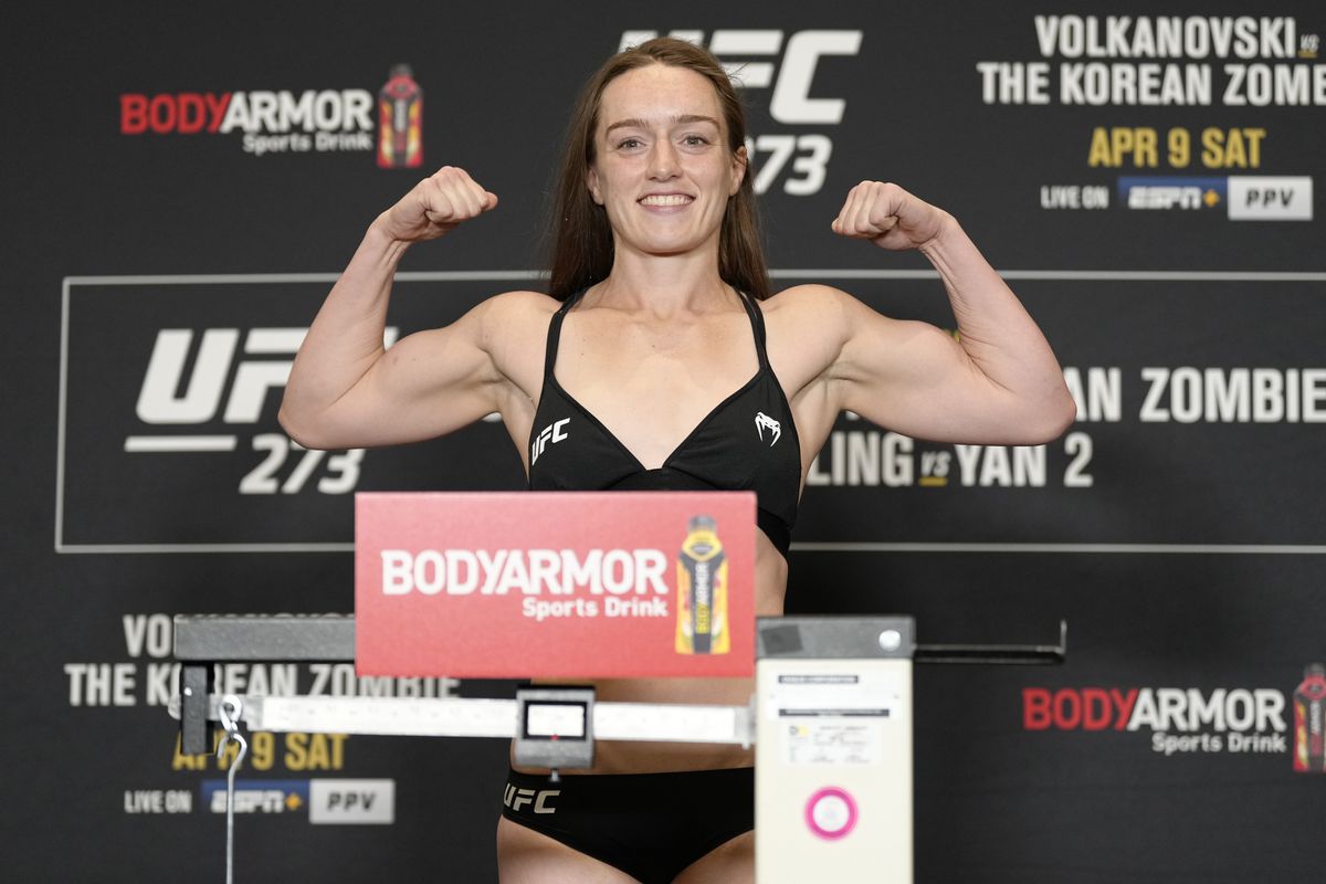 Aspen Ladd poses on the scale during the UFC 273 official weigh-in.