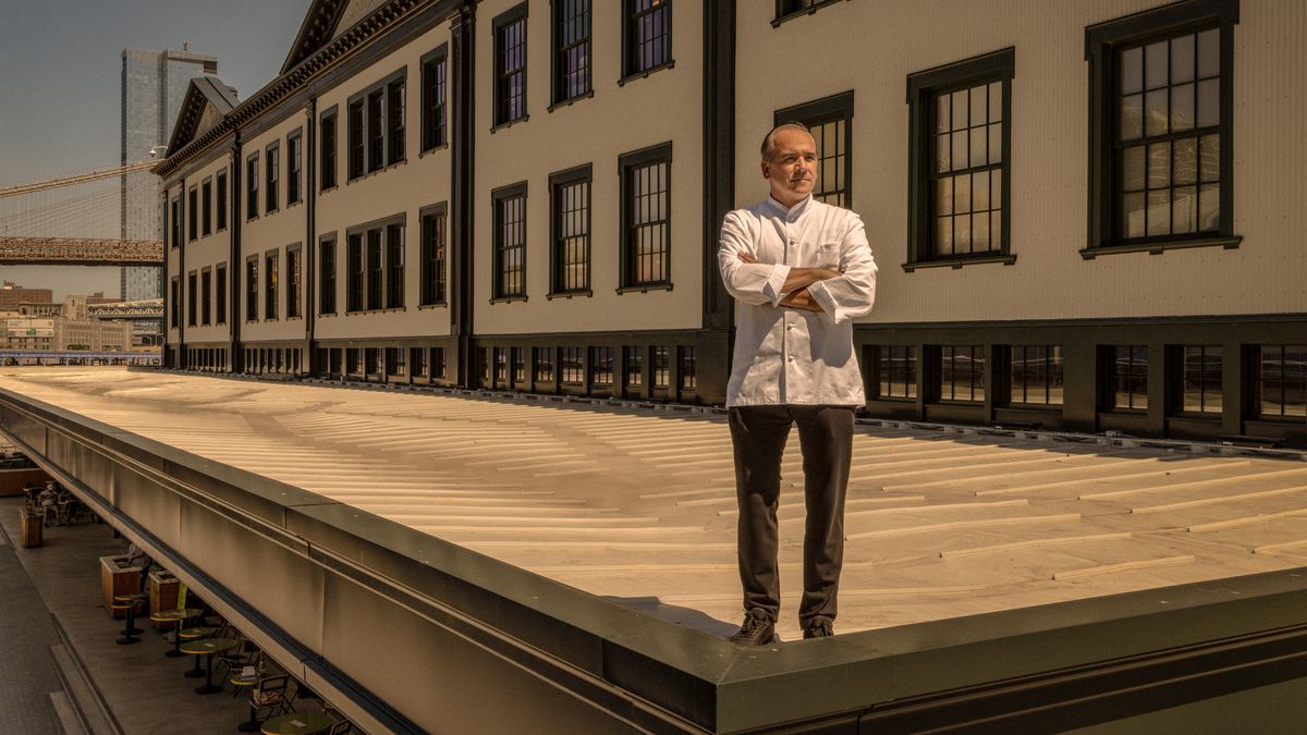 A chef stands on the roof of an historic building that used to be the epicenter of fish sales for the five boroughs.